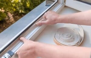 Person applies weather stripping to seal pests out in Suisun city.